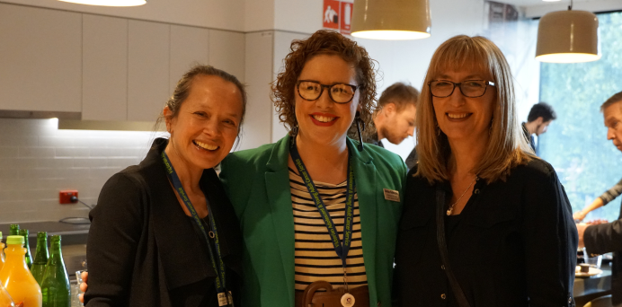 three female members of the AYA team smiling