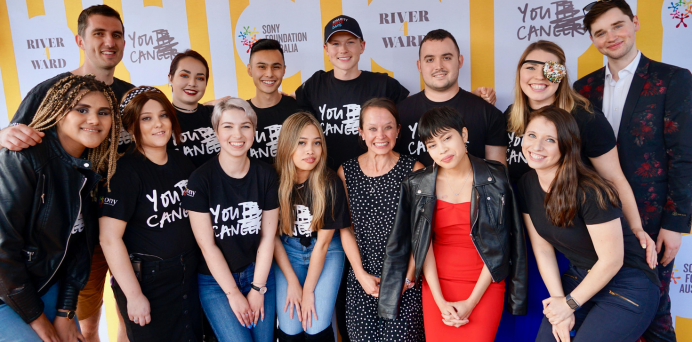 group of youth cancer advocates standing in two rows