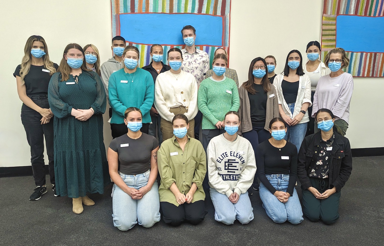 Group of nurses in surgical masks and casual clothes